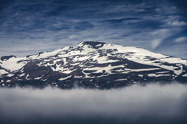 Fog and snow covered mountain