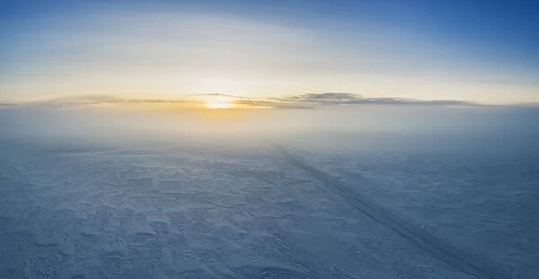 Fog and sunset over snowy road, Iceland