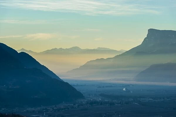 Foggy sunrise in the valley of Merano, Trentino, Italy