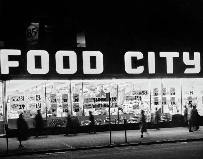 Framed Print : Food City. Pedestrians on the sidewalk pass the illuminated windows of a Food City store Framed Print : Food City. Pedestrians on the sidewalk pass the illuminated windows of a Food City store