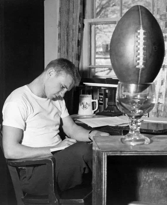 Framed Print : Football Player Working at Desk Framed Print : Football Player Working at Desk