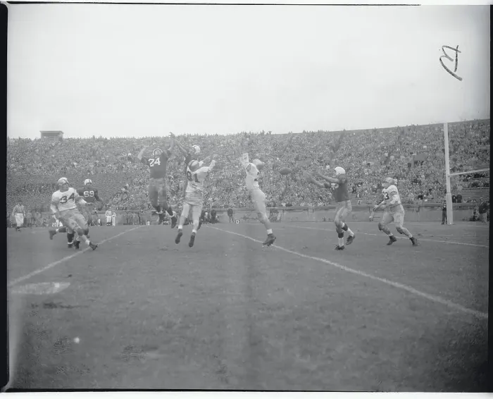 Framed Print : Football Players Leaping for a Pass Framed Print : Football Players Leaping for a Pass