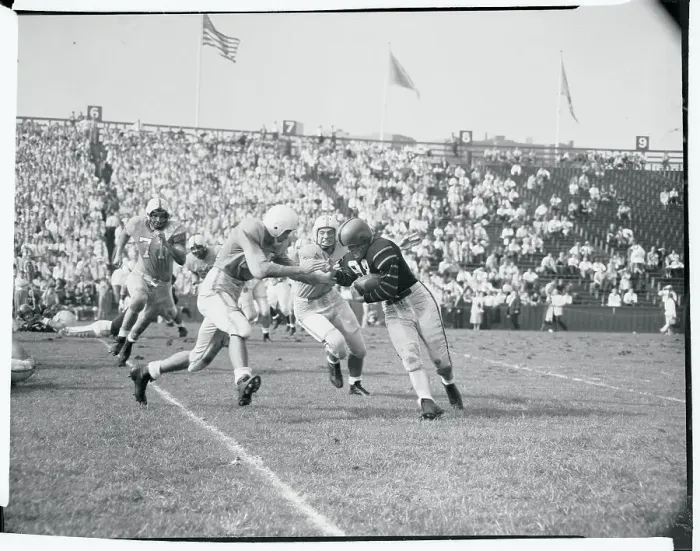 Framed Print : Football Players Tackling an Opponent Framed Print : Football Players Tackling an Opponent