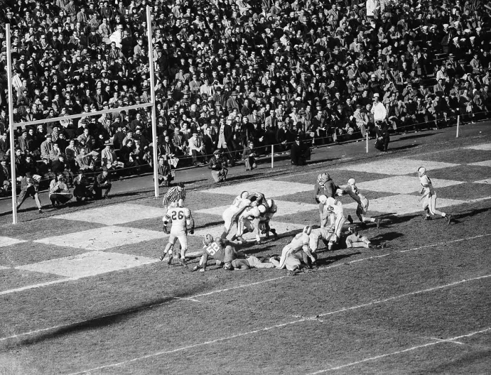 Framed Print : Football Players Tackling an Opponent Framed Print : Football Players Tackling an Opponent