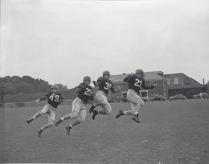 Framed Print : Football Players Working out on Field Framed Print : Football Players Working out on Field