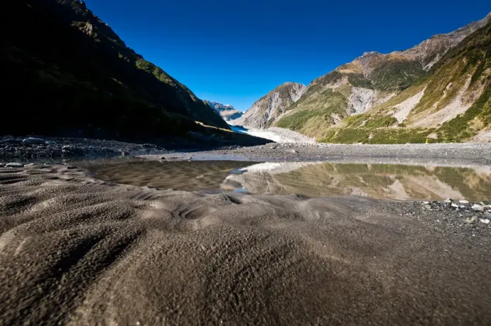 Framed Print : Fox glacier with sand and reflection Framed Print : Fox glacier with sand and reflection