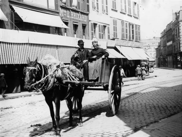 Framed Print : France. circa 1900: Couple driving in a horse and cart up a street in France Framed Print : France. circa 1900: Couple driving in a horse and cart up a street in France