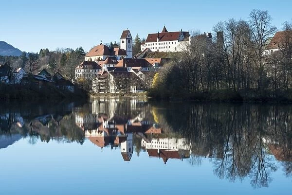 The former Franciscan Monastery of St. Mang, reflection of the castle at top in the Lech river, Fuessen, Ostallgaeu region, Allgaeu, Bavaria, Germany, Europe