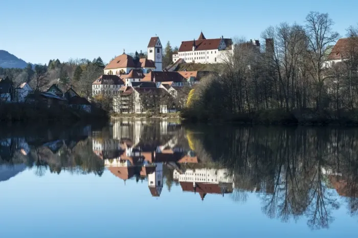 Framed Print : The former Franciscan Monastery of St. Mang, reflection of the castle at top in the Lech river, Fuessen, Ostallgaeu region, Allgaeu, Bavaria, Germany, Europe Framed Print : The former Franciscan Monastery of St. Mang, reflection of the castle at top in the Lech river, Fuessen, Ostallgaeu region, Allgaeu, Bavaria, Germany, Europe