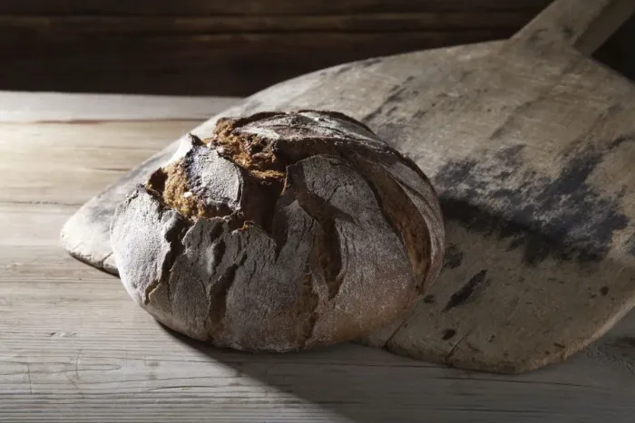 Framed Print : Freshly baked farmhouse bread on an old bread slide Framed Print : Freshly baked farmhouse bread on an old bread slide