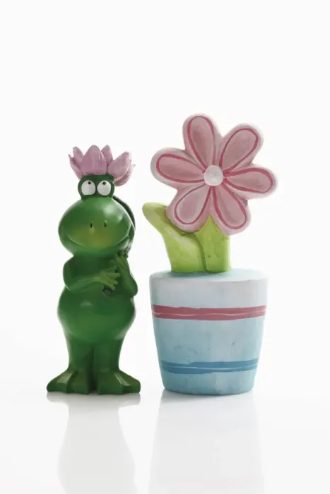 Framed Print : Frog figure with artificial flower pot Framed Print : Frog figure with artificial flower pot