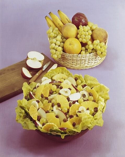 Fruit salad and basket against pink background, , close-up