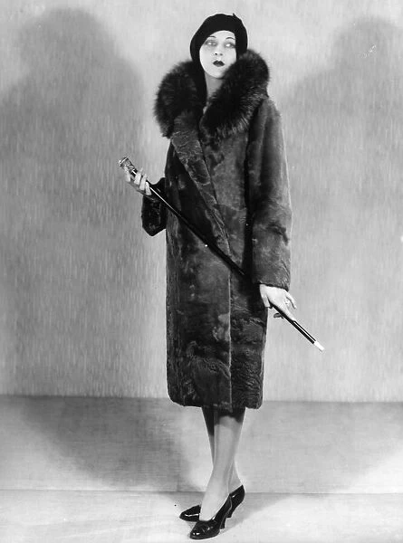 Fur Coat. circa 1929: A fashion model wearing a fur coat