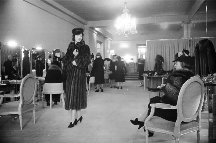 Framed Print : Fur Sale. 19th November 1938: A model shows a customer a mink fur coat