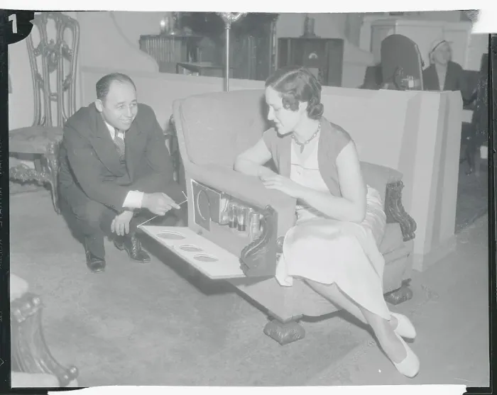 Framed Print : Furniture Designer Louis Davis Demonstrating Chair to Woman Framed Print : Furniture Designer Louis Davis Demonstrating Chair to Woman