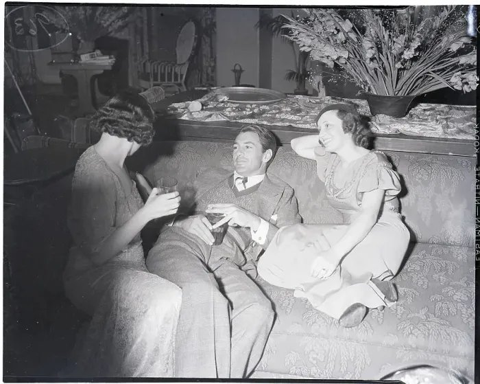 Framed Print : Gary Cooper Relaxes with two Women at Party Framed Print : Gary Cooper Relaxes with two Women at Party