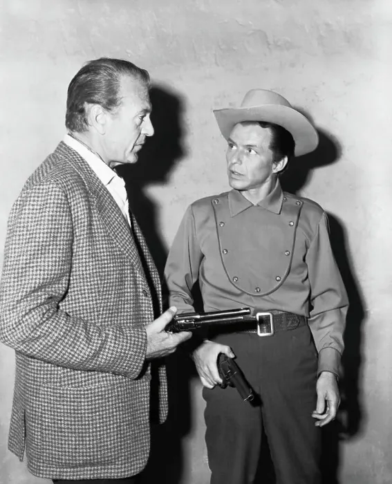 Framed Print : Gary Cooper Showing Frank Sinatra How to Use a Gun