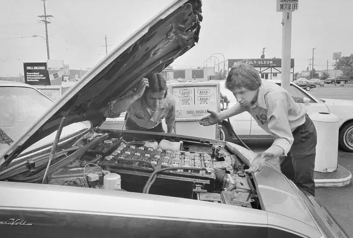 Framed Print : Gas Station Attendants Looking Under Hood of Electric Car Framed Print : Gas Station Attendants Looking Under Hood of Electric Car