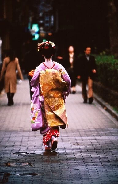 Geisha in kimono walking away, Pontocho districts, Kyoto, Japan
