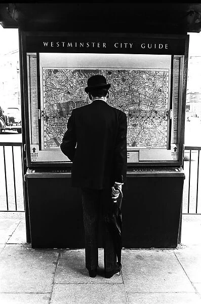 Gentleman in London looking at a city map