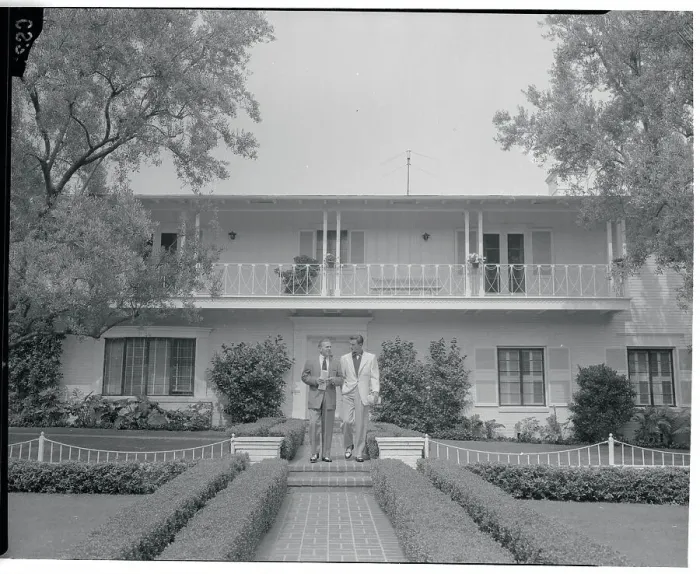 Framed Print : George Burns and Photographer in Front of House Framed Print : George Burns and Photographer in Front of House