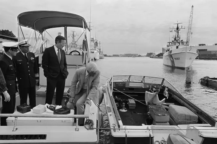 Framed Print : George Bush Inspecting Confiscated Items from a Boat