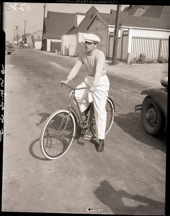 Framed Print : George Raft Seated on Ladies Bicycle Framed Print : George Raft Seated on Ladies Bicycle