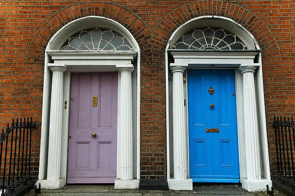 Georgian architecture and painted house doors with red brick facade in Dublin city centre