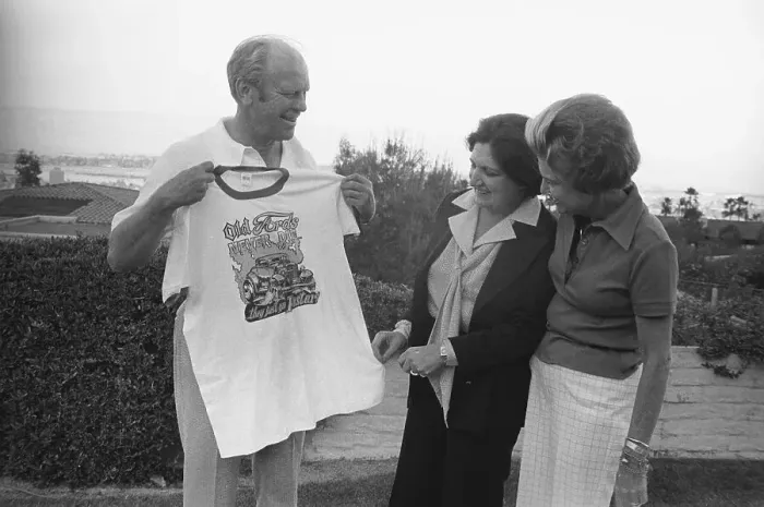 Framed Print : Gerald Ford Holding up Shirt with Wife and Helen Thomas in Observance Framed Print : Gerald Ford Holding up Shirt with Wife and Helen Thomas in Observance