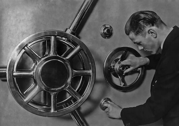 German Bank Vault. A man operating the Triple Safe Lock on the new vault