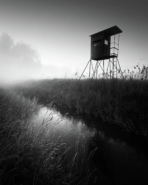 German floodplain landscape in Brandenburg with high seat on the Nuthe in black and white, Luckenwalde, Germany