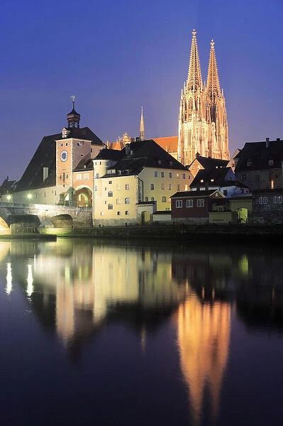Germany, Bavaria, Regensburg, Cathedral and old town gate and Danube river at night