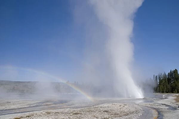 A Geyser With Water Shooting Out And Forming A Rainbow