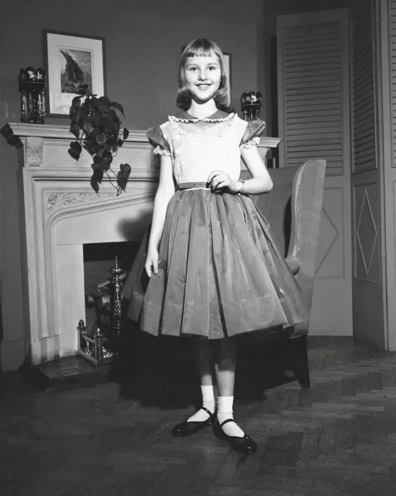 Framed Print : Girl (12-13) posing by fireplace, (B&W), portrait Framed Print : Girl (12-13) posing by fireplace, (B&W), portrait