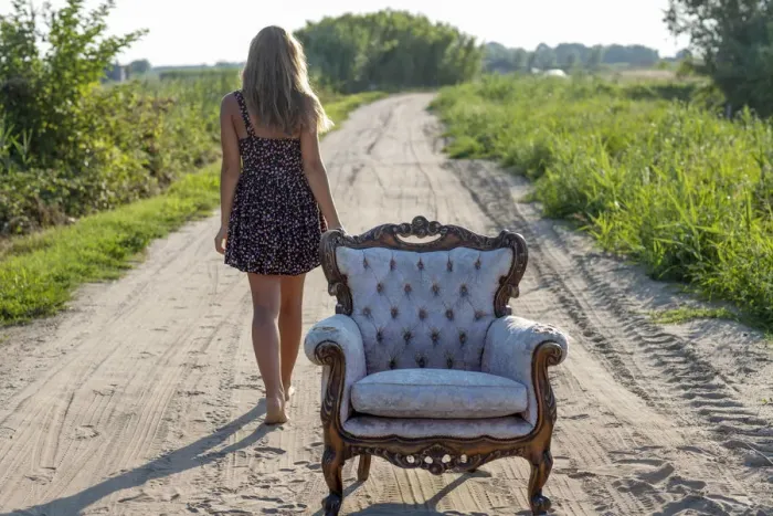 Framed Print : Girl, 14 years, walking along a track, an old armchair in front Framed Print : Girl, 14 years, walking along a track, an old armchair in front