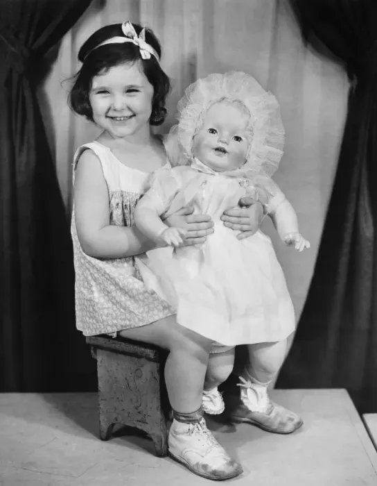 Framed Print : Girl (4-5) holding doll, posing in studio (B&W), portrait