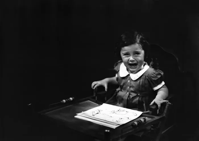 Framed Print : Girl (4-5) sitting in high chair, crying, (B&W) Framed Print : Girl (4-5) sitting in high chair, crying, (B&W)