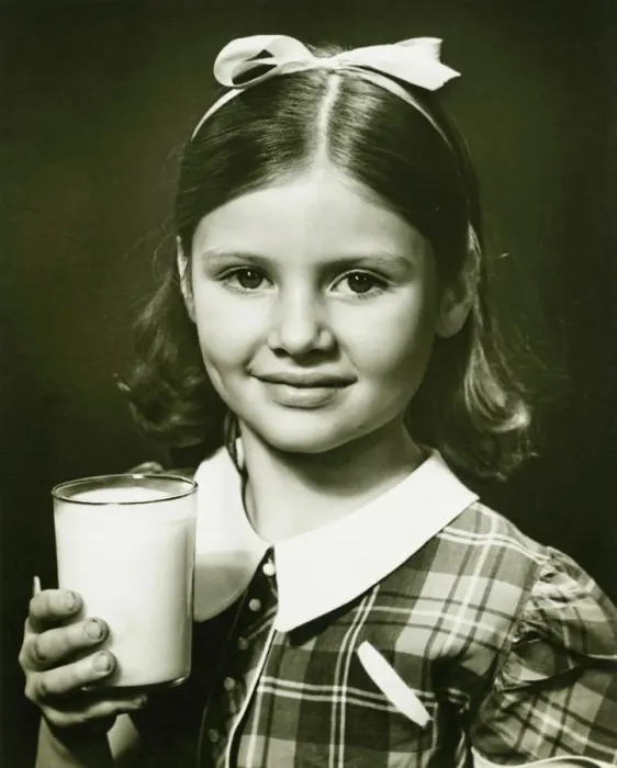 Framed Print : Girl (6-7) holding glass of milk, posing in studio, (B&W), close-up, portrait Framed Print : Girl (6-7) holding glass of milk, posing in studio, (B&W), close-up, portrait