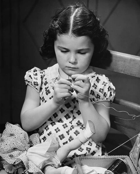 Girl (6-7) threading needle, (B&W)