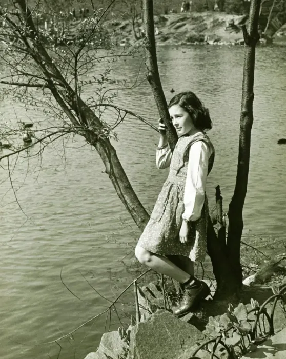 Framed Print : Girl (8-9) leaning on tree trunk by water, (B&W), elevated view Framed Print : Girl (8-9) leaning on tree trunk by water, (B&W), elevated view
