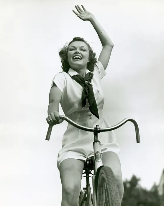 Framed Print : Girl on bike, waving Framed Print : Girl on bike, waving