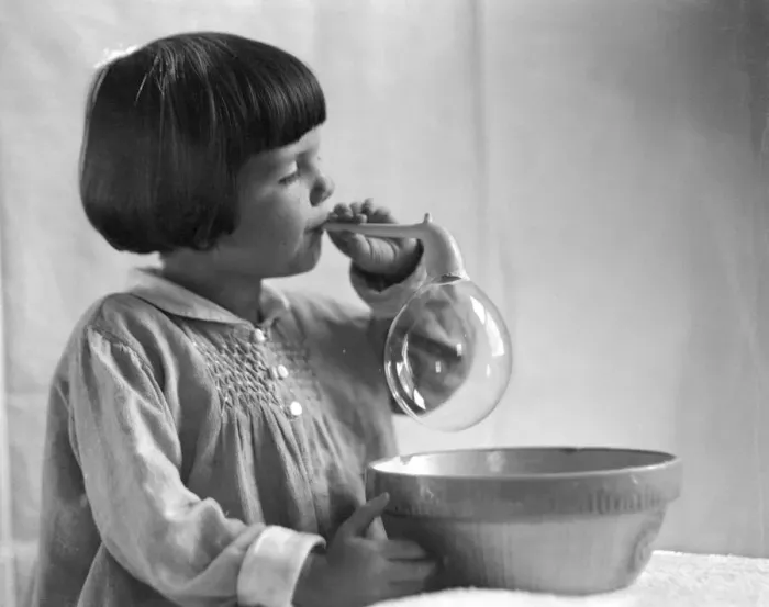 Framed Print : Girl with bobbed hair, blowing bubbles Framed Print : Girl with bobbed hair, blowing bubbles