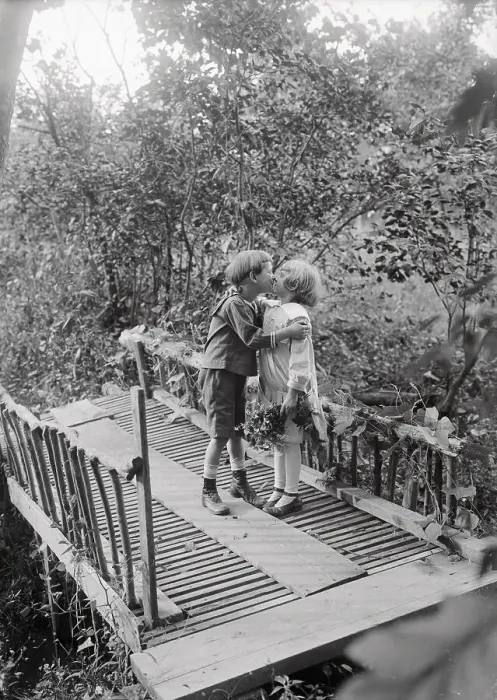 Framed Print : Girl and boy (6-7 years) kissing on bridge. August 05, 1925 Framed Print : Girl and boy (6-7 years) kissing on bridge. August 05, 1925