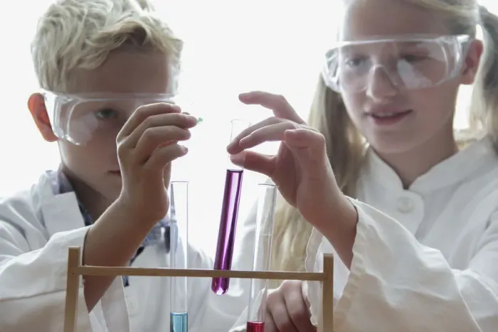 Framed Print : Girl and boy playfully doing chemistry experiments