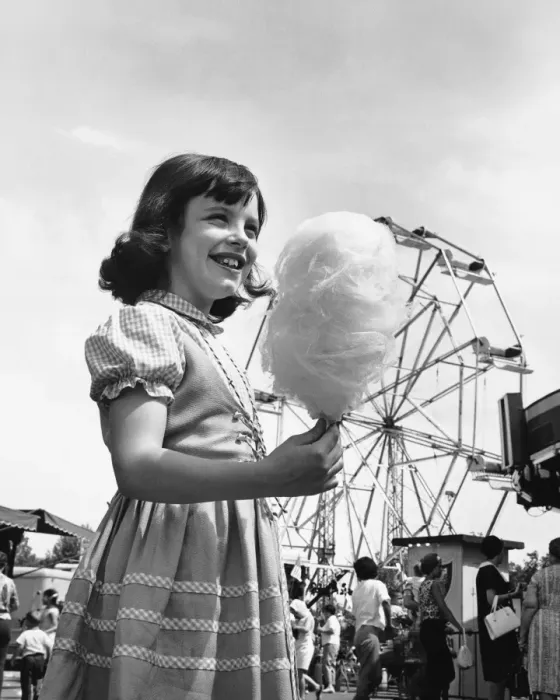 Framed Print : Girl eating cotton-candy at fair