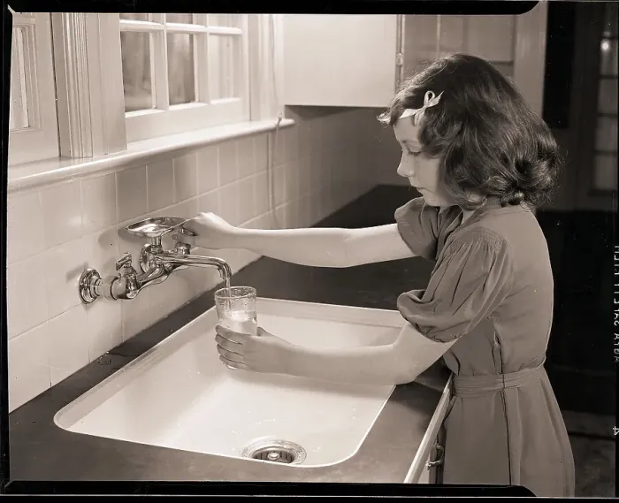 Framed Print : Girl Filling Glass with Water Framed Print : Girl Filling Glass with Water