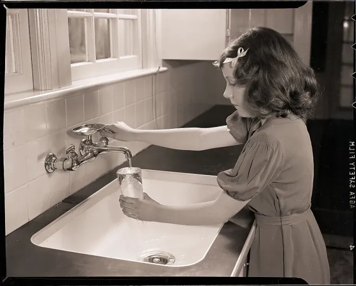 Framed Print : Girl Filling Glass with Water Framed Print : Girl Filling Glass with Water
