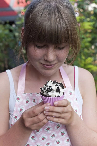 Girl looking at a homemade Oreo brownie cupcake