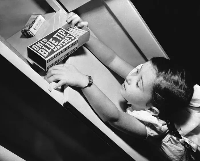 Framed Print : Girl Pulling Matches Off Shelf Framed Print : Girl Pulling Matches Off Shelf