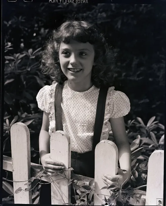 Framed Print : Girl Smiling Behind Fence Framed Print : Girl Smiling Behind Fence